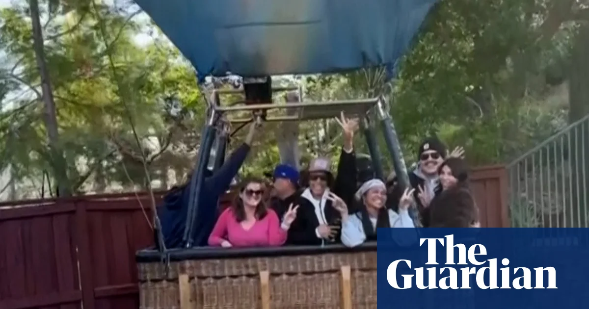 Hot-air balloon with 13 people lands in California back yard – video | California